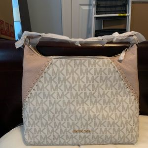 NWT Michael Kors Aria bag with crossbody strap.